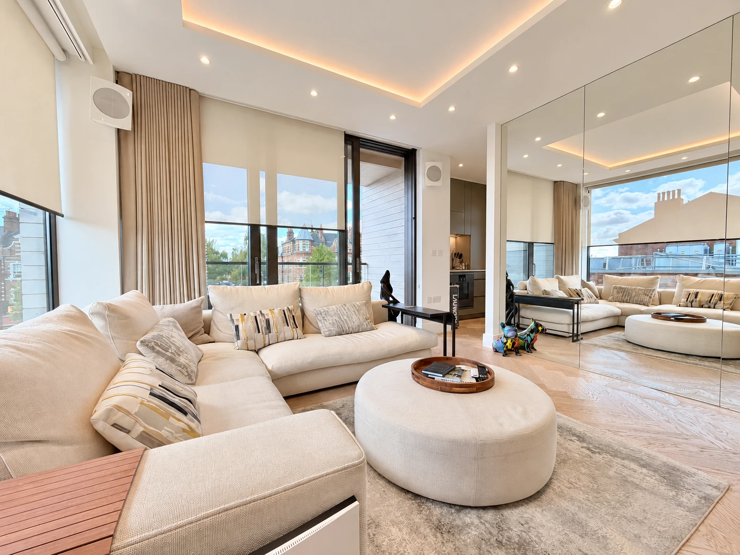 Belsize apartment with a bright living area, mirrored walls and a private balcony