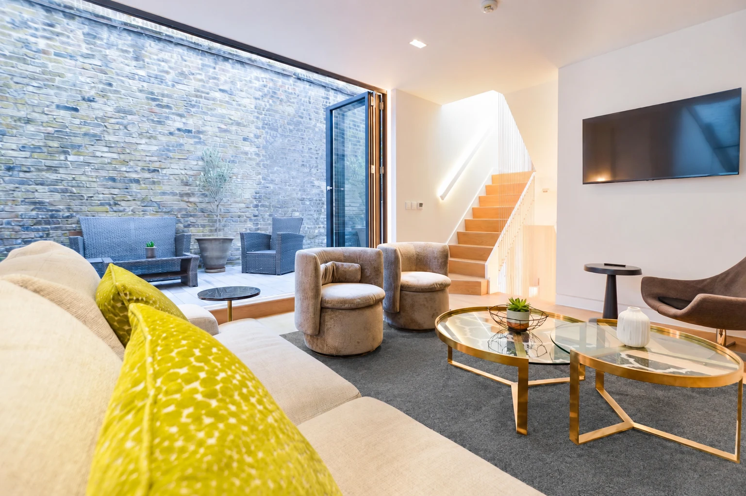 Soho Mews House living area with a courtyard and oak staircase